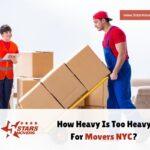 How to Save Money on Local Moving Services 1 Two movers in a spacious room are handling cardboard boxes. A woman in an orange safety vest holds a clipboard, while a man in blue overalls pushes a dolly loaded with heavy boxes. The image illustrates the challenges of lifting heavy items for movers in NYC.